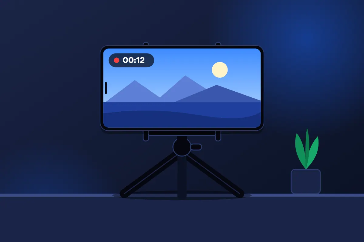 Telefon nagrywający wideo na małym statywie stojącym na biurku
